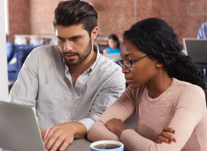 people looking at laptop